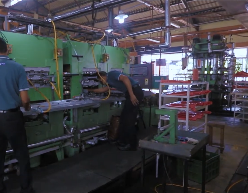 Rubbertechno team operating moulding presses on the factory floor